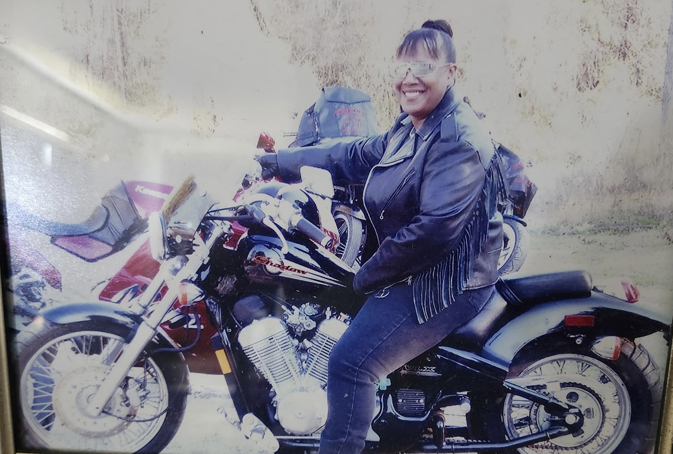 Gwen sitting on a motorcycle